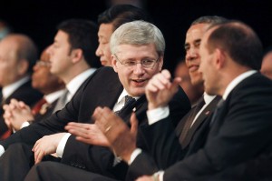 Canadian Prime Minister Stephen Harper speaks with U.S. President Barack Obama and Australian Prime Minister Tony Abbott as they watch a cultural performance at the G20 Leaders Summit in Brisbane